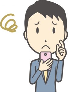 スマホで躊躇する男性