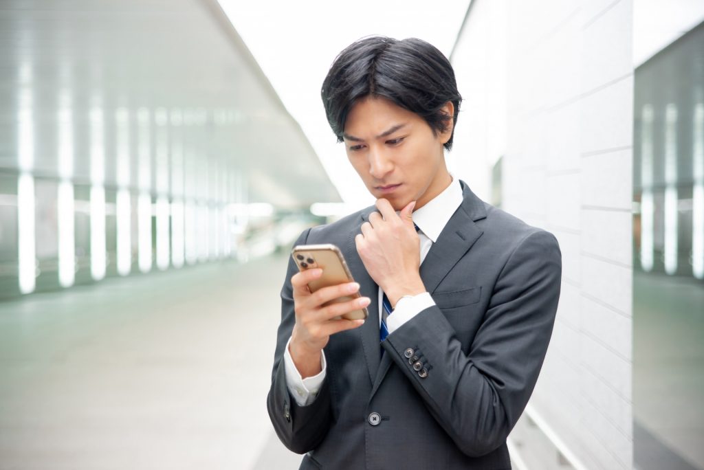 スマートフォンを見て不満顔